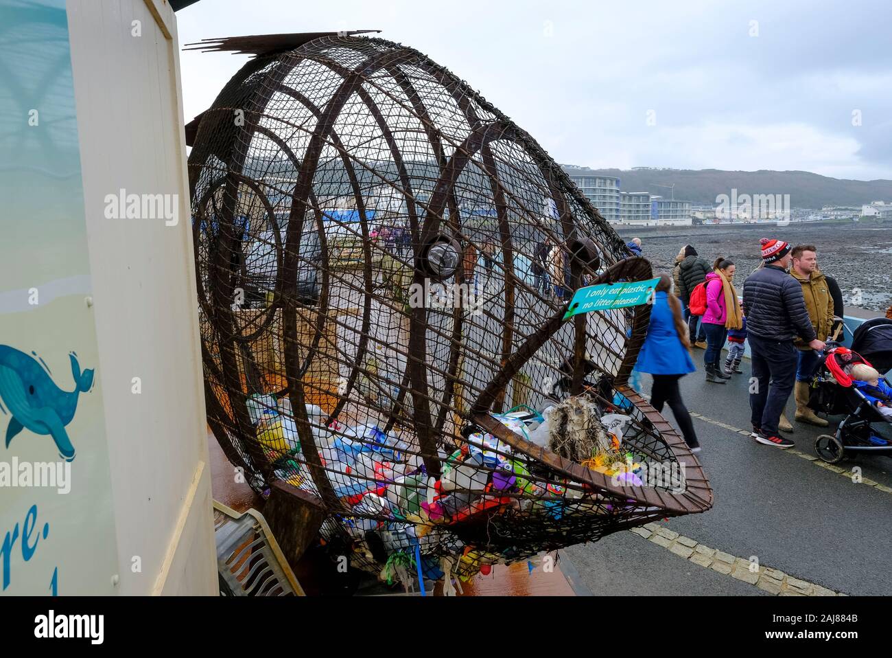 Filup The Fish, created by metal artist Robert Floyd, for plastic waste bottle collection on the promenade at Westward Ho! North Devon, UK Stock Photo