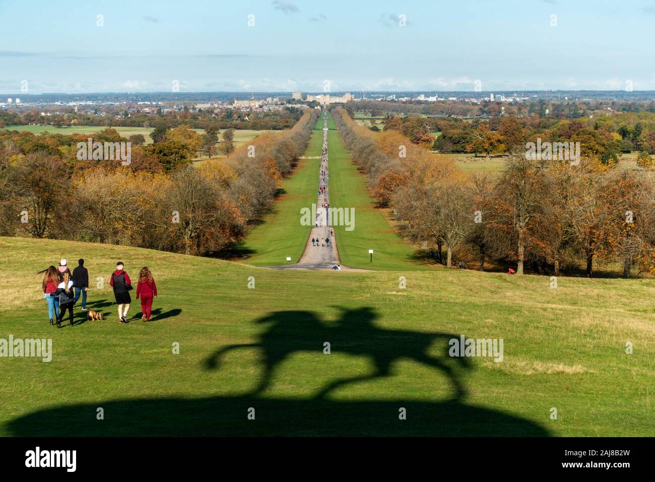 View along the Long Walk from Snow Hill with shadow of statue of King George III in foreground, Windsor Great Park, Windsor, Berkshire, England, UK Stock Photo