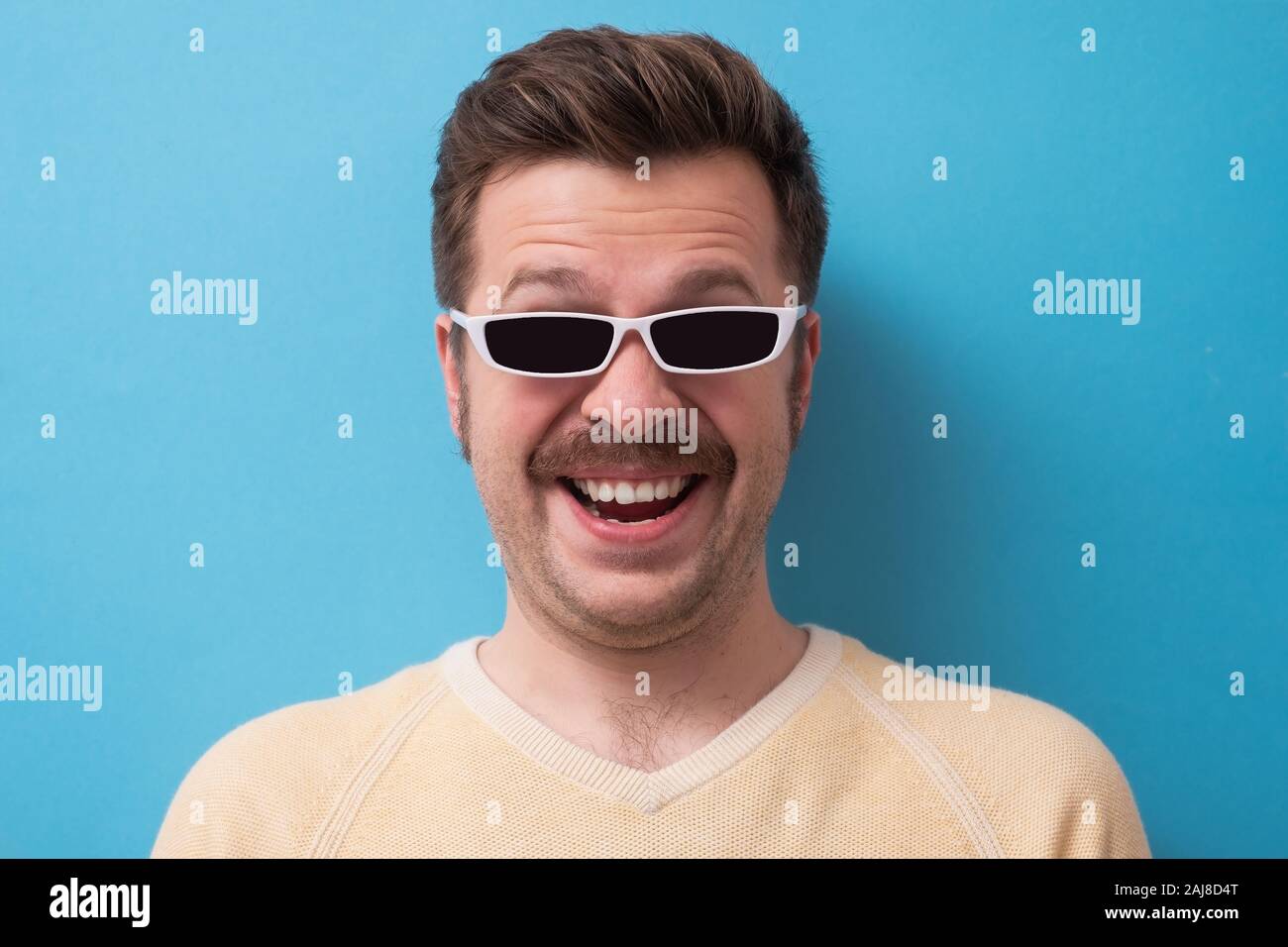 geek retro caucasian man with funny mustache sunglasses with serious