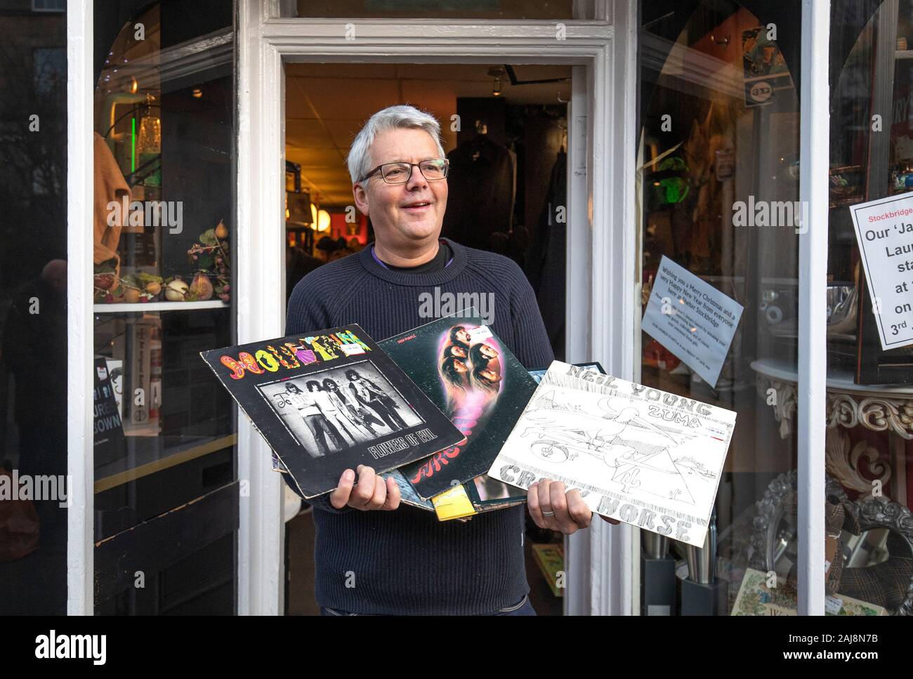 Record collector Graeme Sneddon with some vinyl records he bought at the launch of the designer goods sale at Shelter Scotland's shop in Stockbridge, Edinburgh. Stock Photo