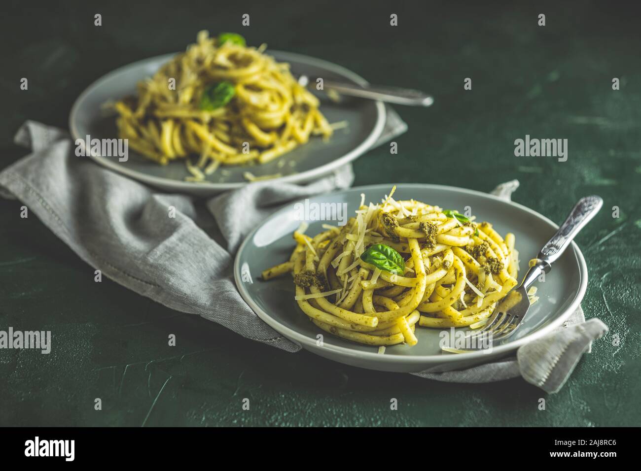 Spaghetti pasta bucatini with pesto sauce and parmesan. Italian