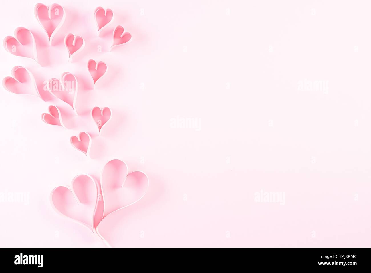 Pink paper hearts on Light pink pastel paper background. Love and  Valentine's day concept Stock Photo - Alamy
