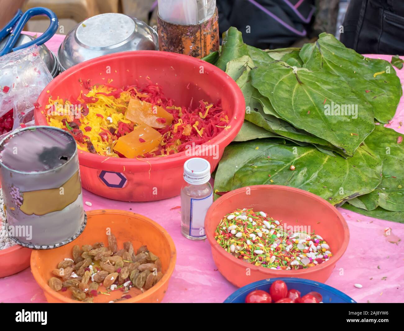 Different types of colorful garnish pan masala used to decorate betel leaf banarasi paan with selective focus Stock Photo