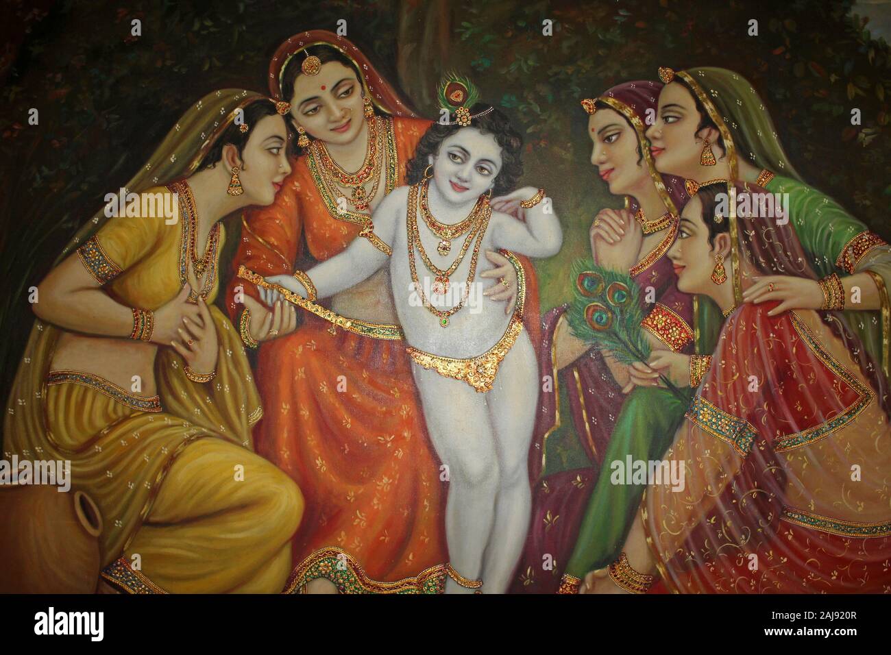 Painting showing a young Krishna surrounded by women devotees Stock Photo