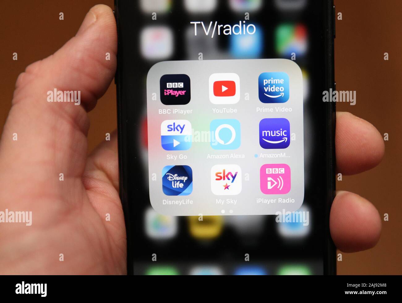 A person holds an iphone showing various apps inclusing BBC IPlayer,  YouTube, Amazon Prime, Amazon Music, Sky Go, Disney Life and Amazon Alexa.  PA Photo. Picture date: Friday January 3, 2020. Photo