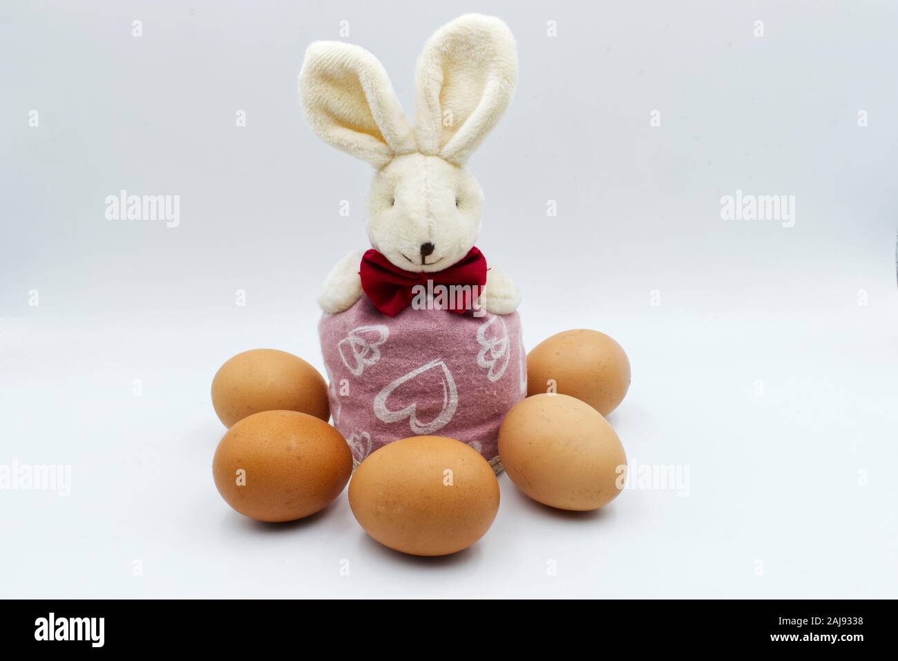 Easter rabbit with eggs isolated on white background. Traditional easter decoration Stock Photo