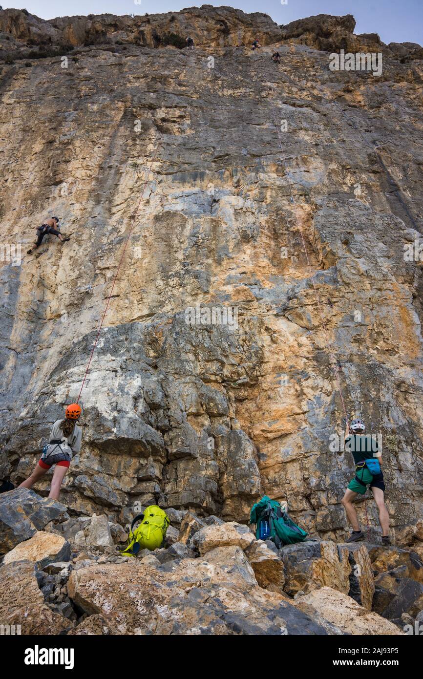 Woman Belaying Rock Climbers on Telendos Island, Kalymnos, Greece Stock Photo