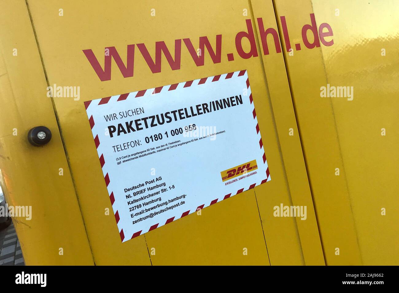 Munich, Deutschland. 30th Dec, 2019. Stickers, sign PACKAGE DELIVER WANTED on the rear door of a DHL parcel transporter, parcel carrier, deliverer, Deutsche Post AG. DHL, parcel, parcels, parcel service, deliver, deliver, unload, send, transporter, | usage worldwide Credit: dpa/Alamy Live News Stock Photo