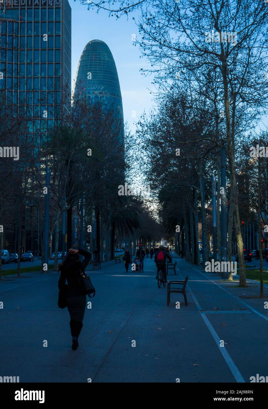Pedestrian walkway on Avinguda Diagonal with office building and Torre Glories (formerly known as Torre Agbar) towering above, Barcelona, Spain Stock Photo