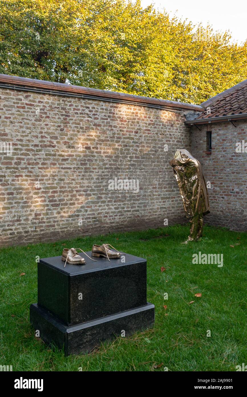 Bruges, Belgium - October 6, 2018: Sculpture of Jan Fabre - The Man who gives a light in Guido Gezelle museum yard in Bruges Stock Photo