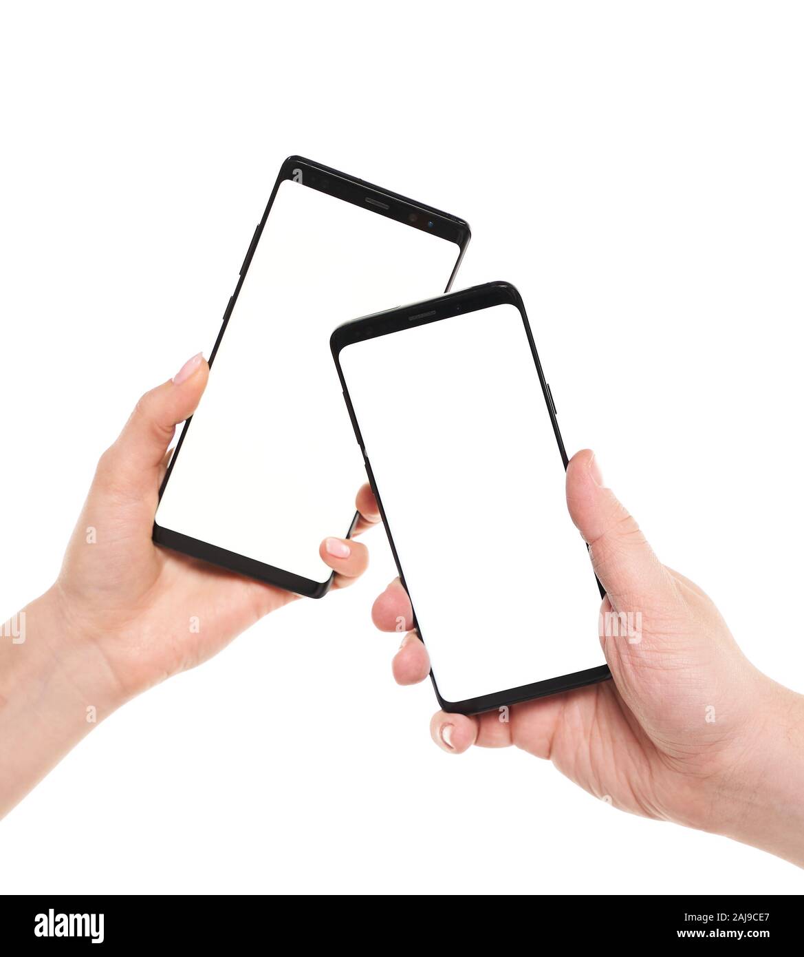 Two hands holding smartphones blank screen with modern frameless design ...
