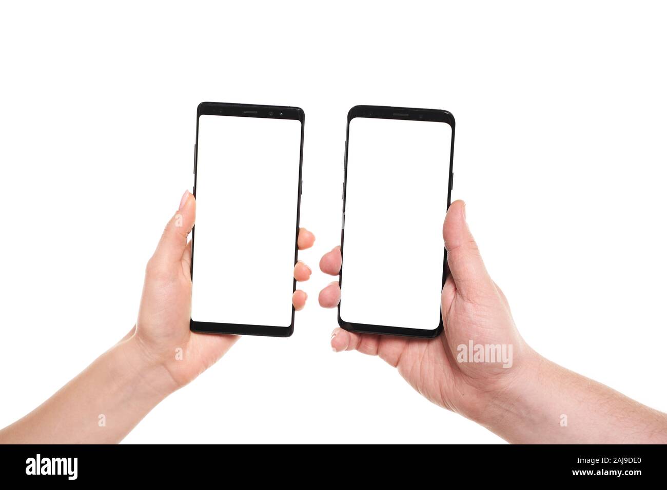 Two hands holding smartphones blank screen with modern frameless design ...