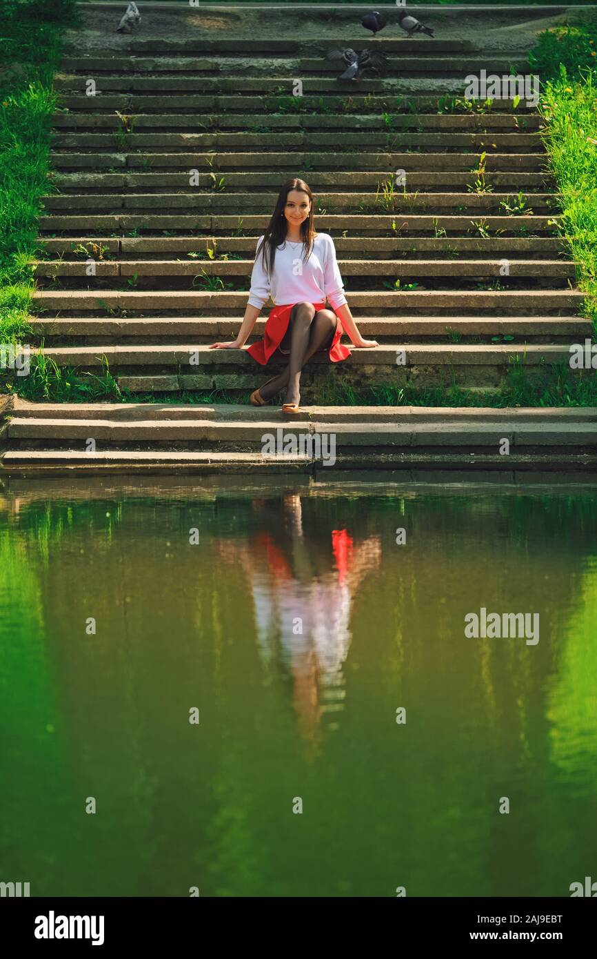 Woman sitting on stairs skirt hi-res stock photography and images - Alamy