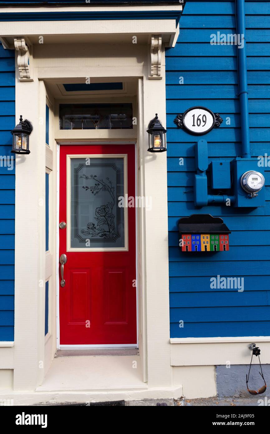 Facade of a house in St John's, Newfoundland and Labrador, Canada. The house has a red door. Stock Photo