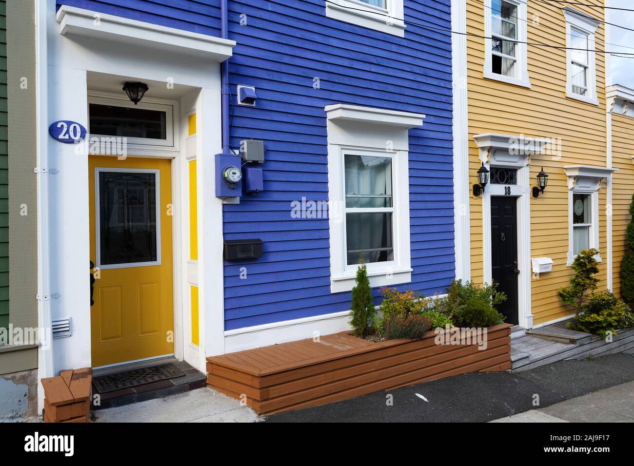 Facades colourful houses in St John's, Newfoundland and Labrador, Canada. Plants thrive outside of the buildings. Stock Photo