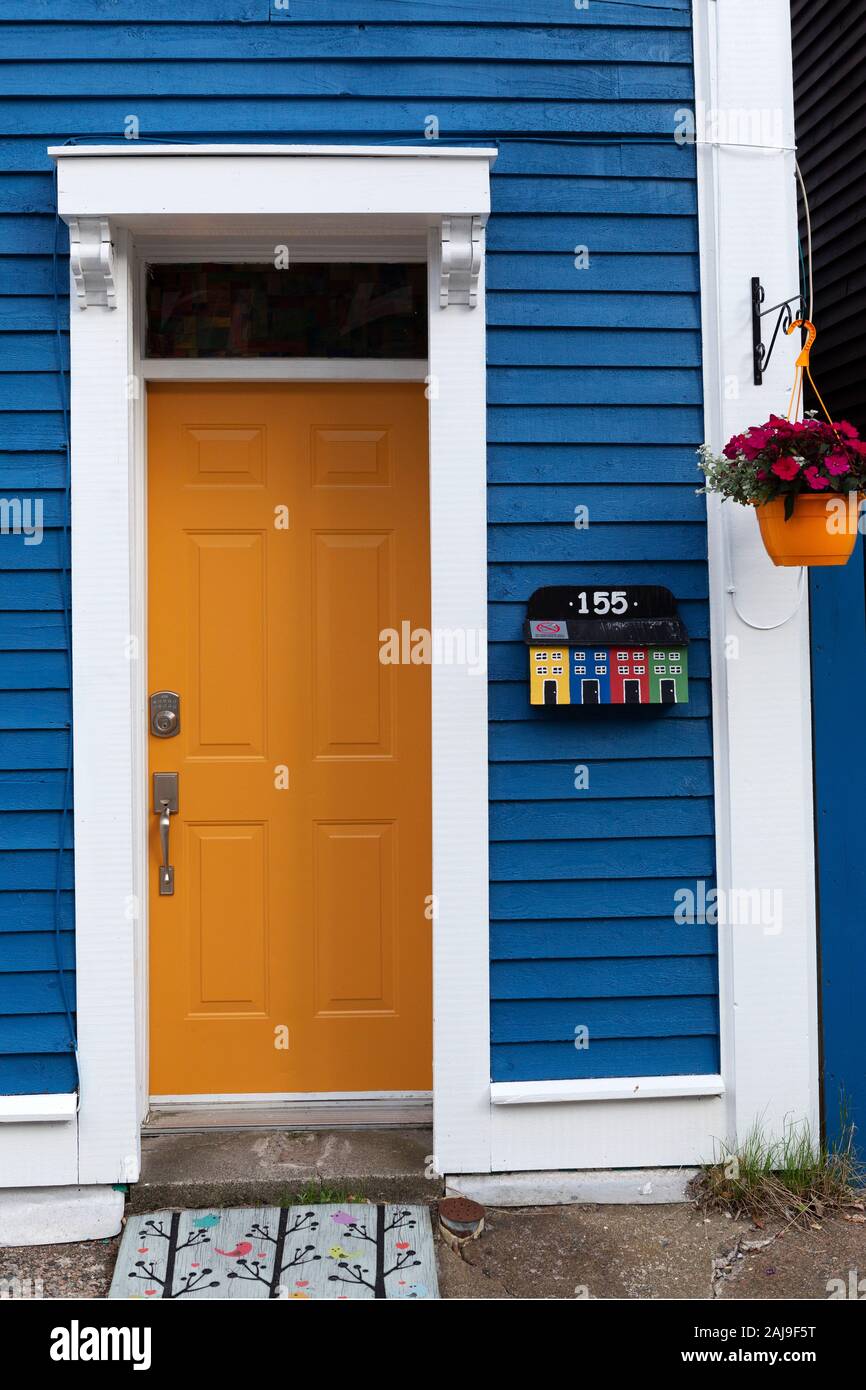 Facade of a house in St John's, Newfoundland and Labrador, Canada. The house has a yellow door. Stock Photo