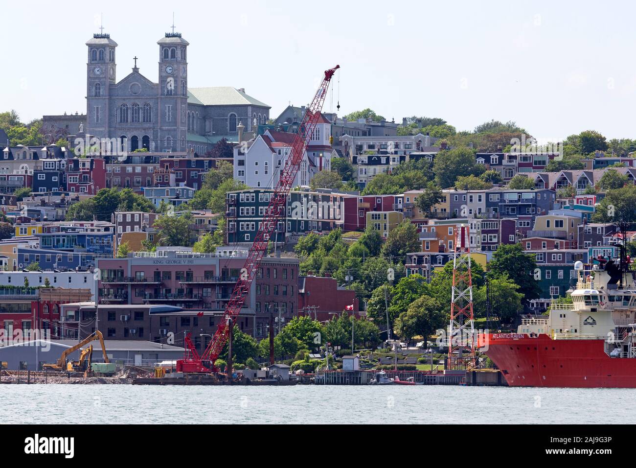 Buildings in St John's, Newfoundland and Labrador, Canada. The Anglican Cathedral of Saint John the Baptist towers over the city. Stock Photo