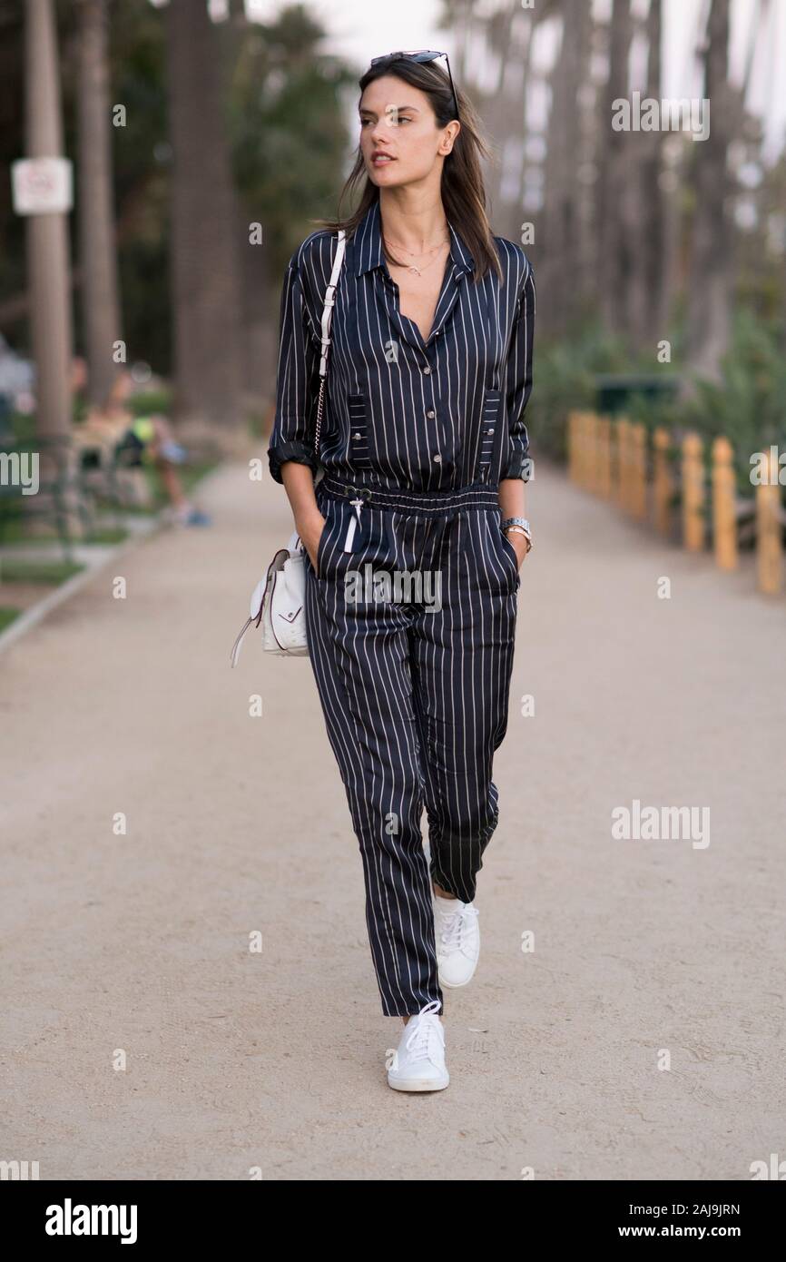 LOS ANGELES, CA - JUNE 12:  Alessandra Ambrosio is wearing a blue jumpsuit from Anthony Vaccarello and a white leather bag in the streets of LA. Stock Photo