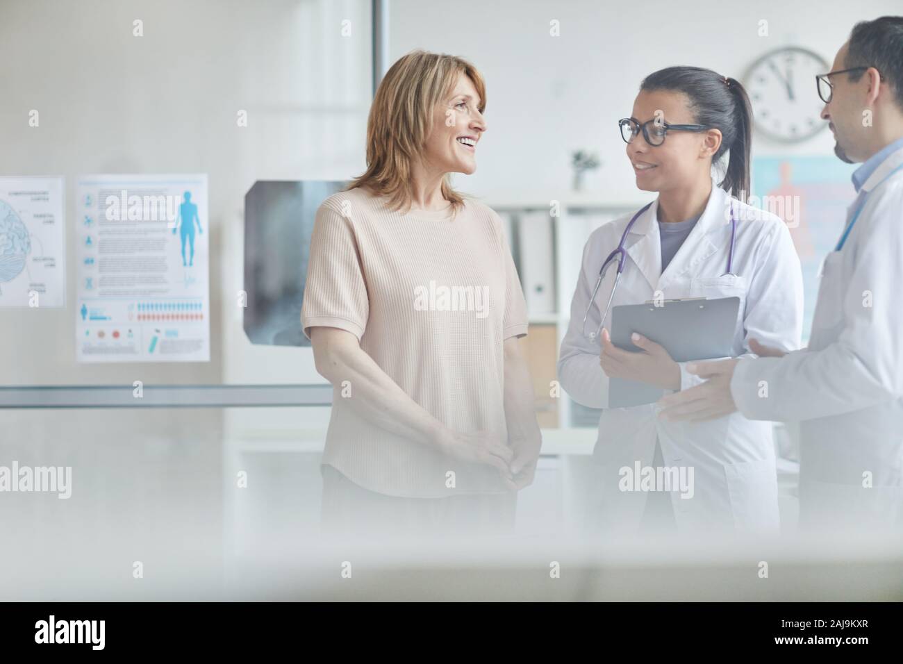 Smiling mature doctor talking hi-res stock photography and images - Alamy