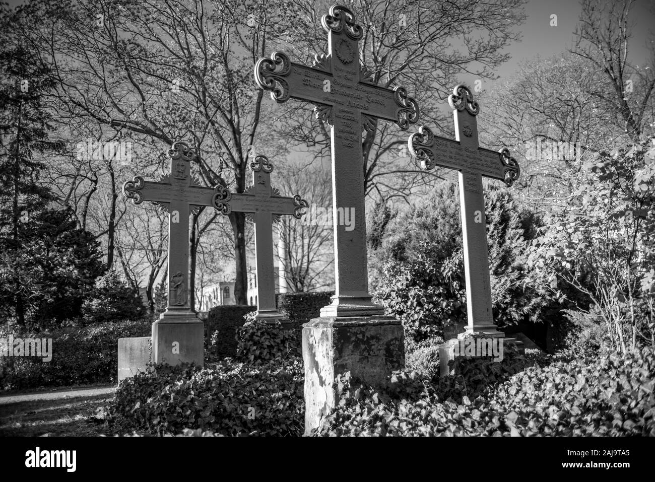 Old weathered crosses on a german graveyard in Berlin on a bright winter day Stock Photo