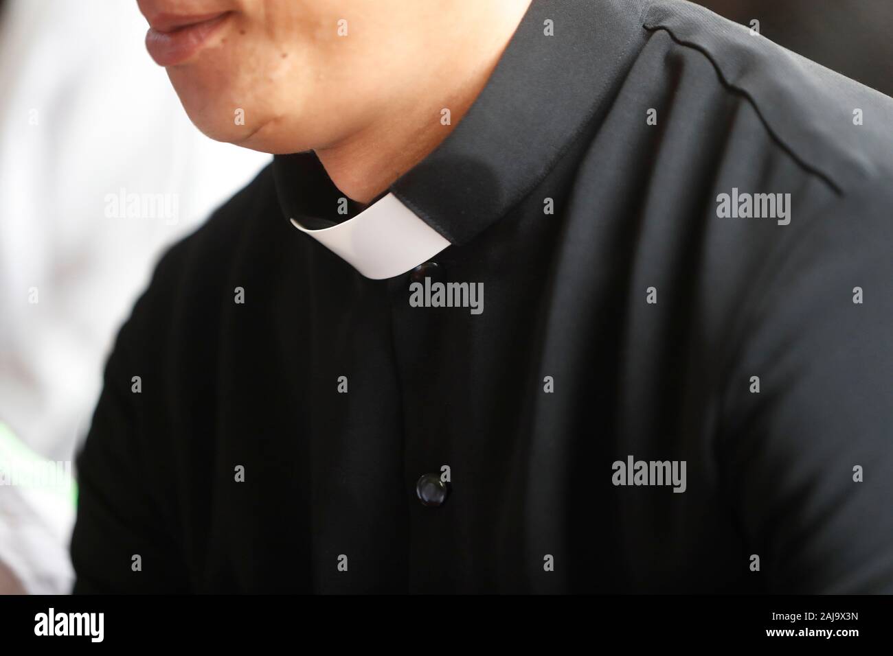Priest wearing clerical shirt with a tab collar Stock Photo
