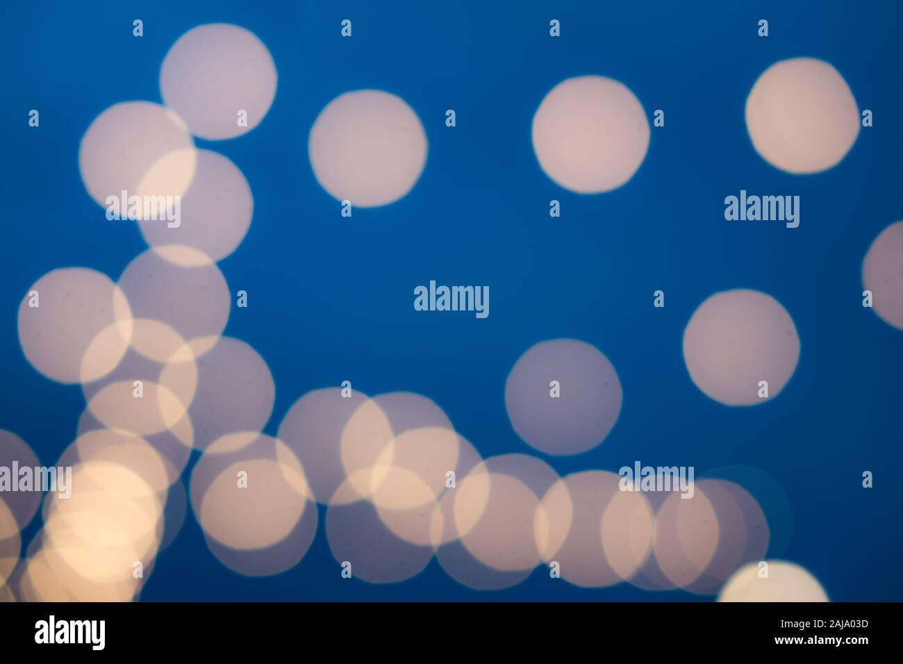 Abstract orange bokeh light texture on blue background Stock Photo - Alamy