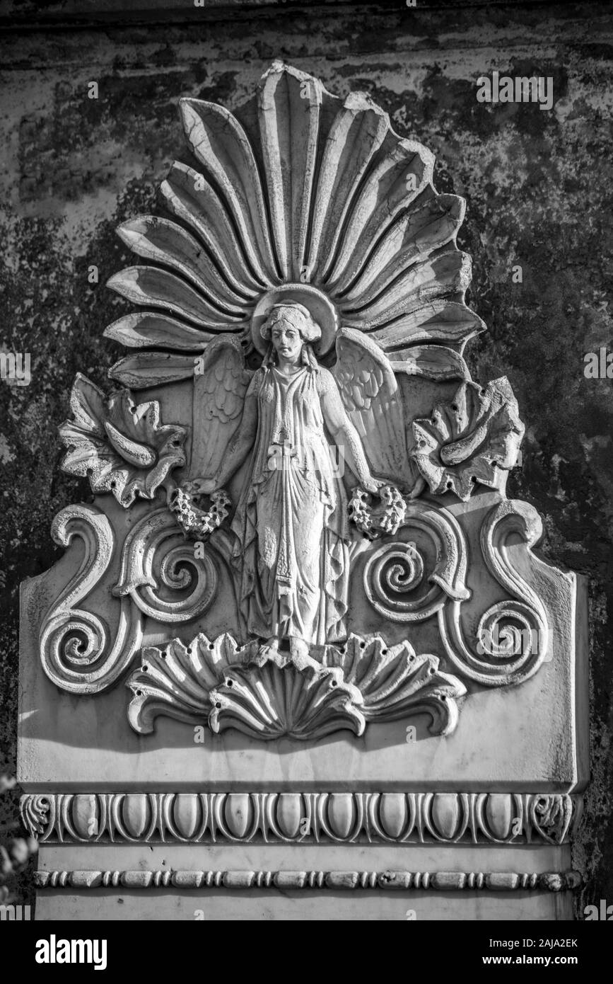 Detailed ancient stone relief of a woman on a german cemetery in Berlin Stock Photo