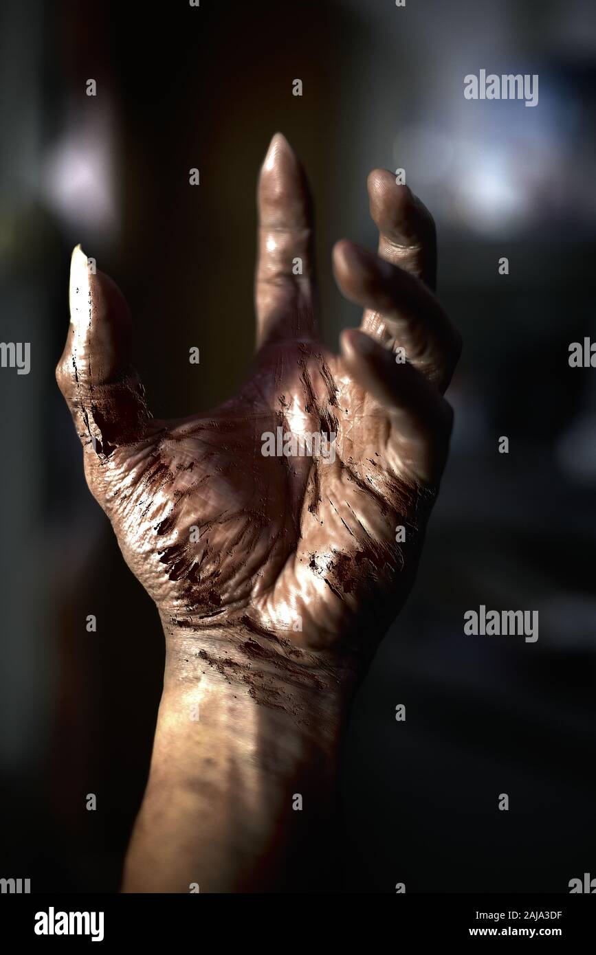 bloody horrific hands with evil background Stock Photo