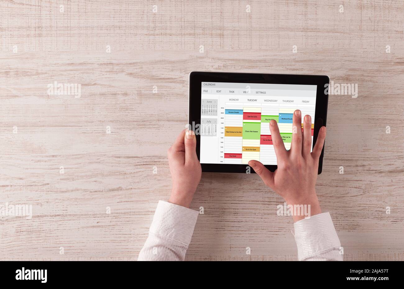 Hand holding tablet with timetable and calendar concept Stock Photo - Alamy