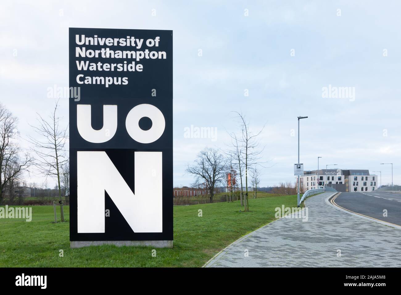 Northampton, Northamptonshire, UK: Sign for the University of Northampton Waterside Campus next to a road leading to a building on the site. Stock Photo