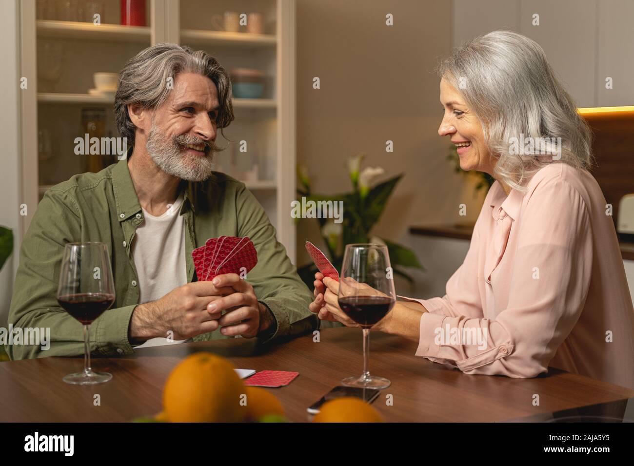 Woman holding playing cards with both hands Stock Photo
