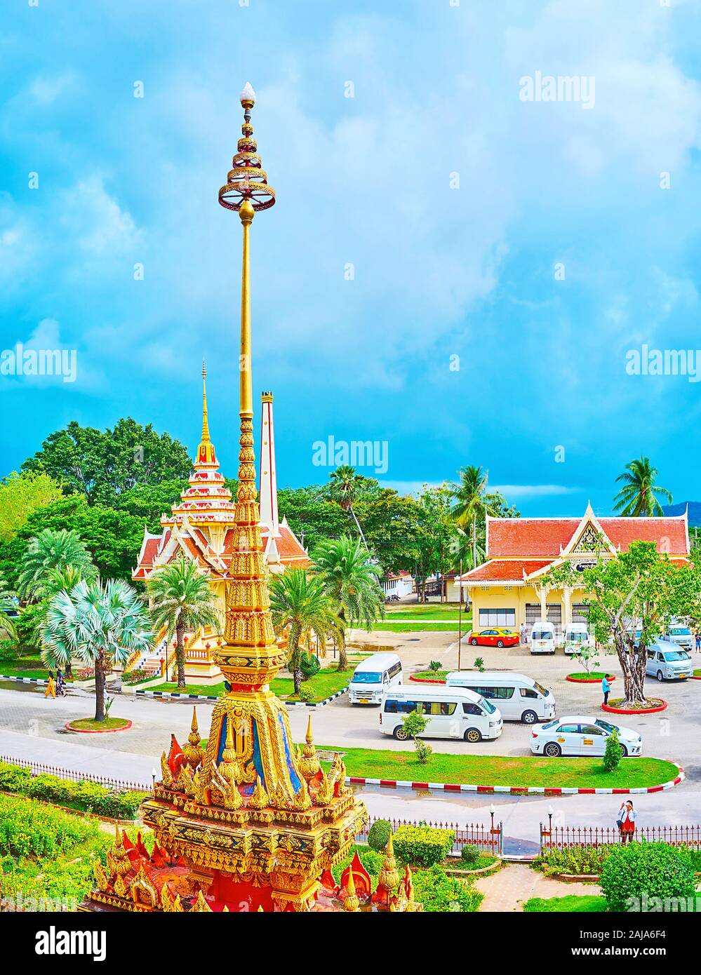 CHALONG, THAILAND - APRIL 30, 2019: The spire and hti umbrella finial of the chedi in front of the shrines of Wat Chalong temple, on April 30 in Chalo Stock Photo