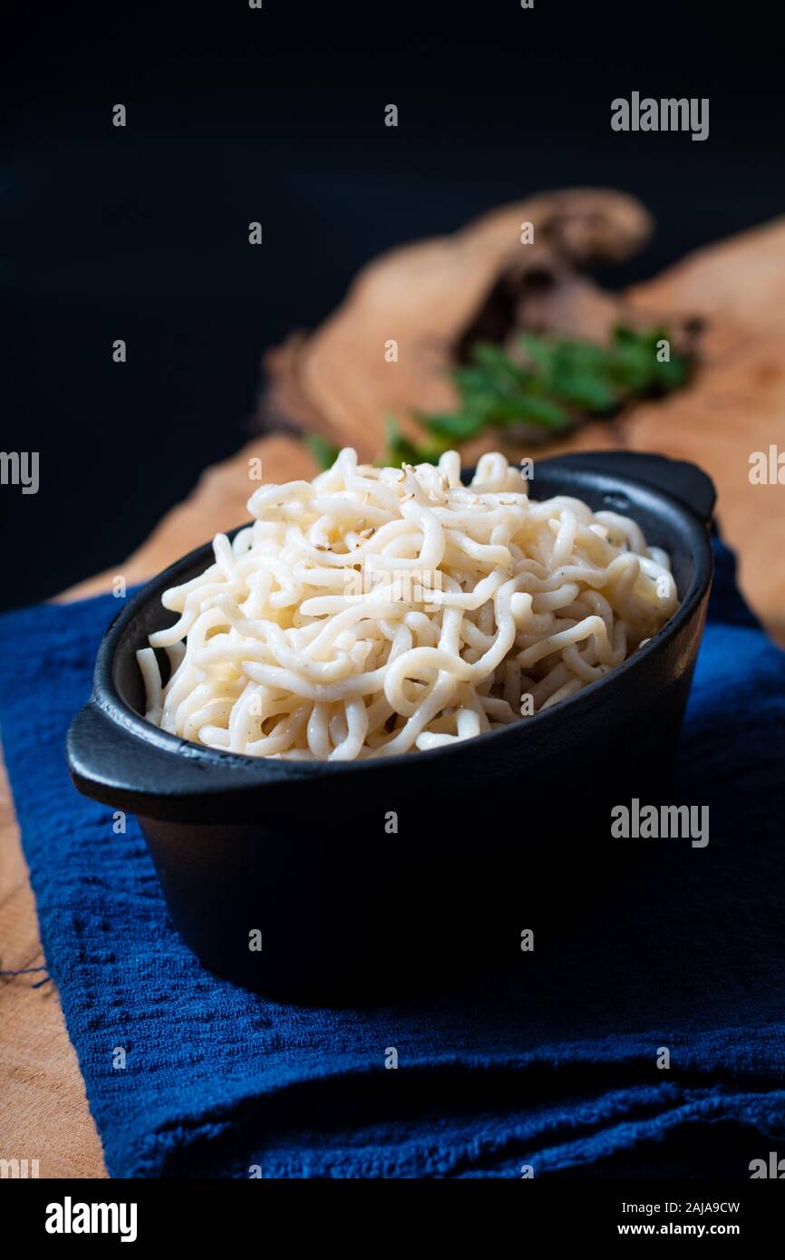 Healthy food concept organic Noodle or spaghetti Shirataki Konjac in black ceramic cup with copy space Stock Photo