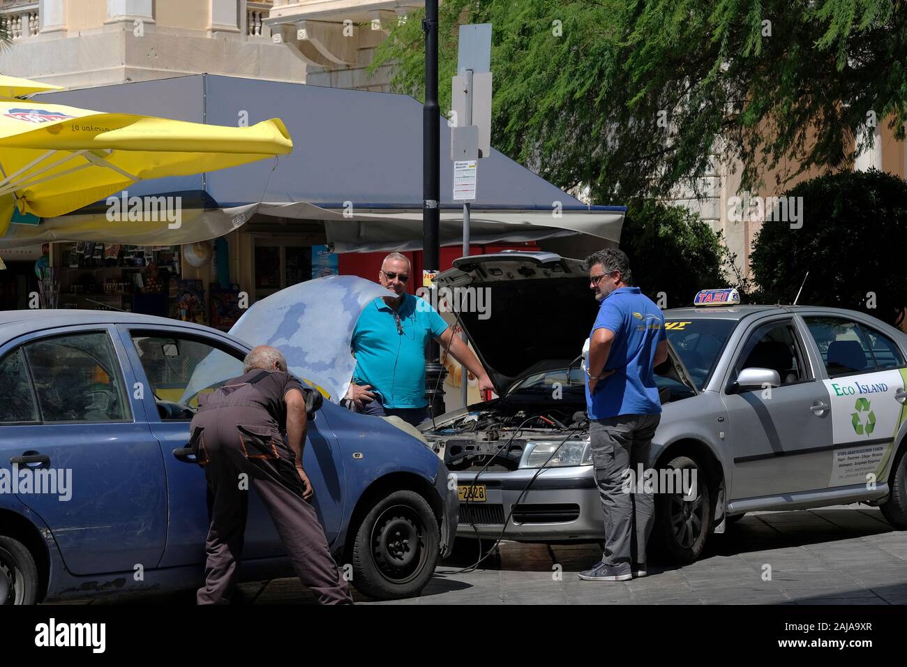 A mechanic fixing a broken down car in Syros, Greece. Stock Photo