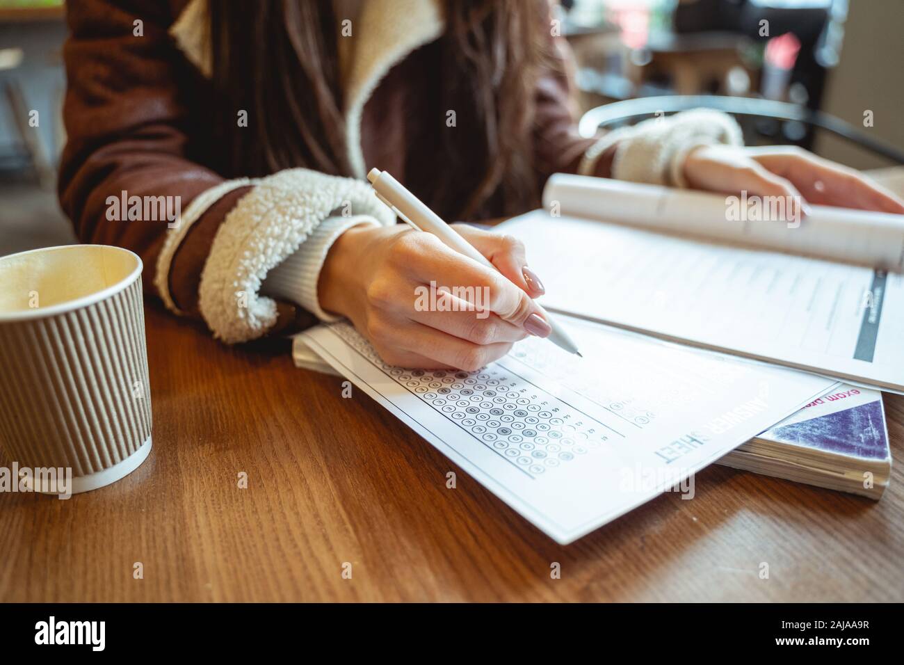 Pretty student doing grammar test in English Stock Photo - Alamy