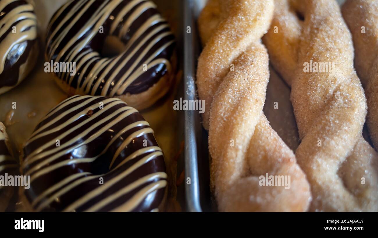 Chocolate Glazed Donuts and Sugar Coated Twists Stock Photo Alamy