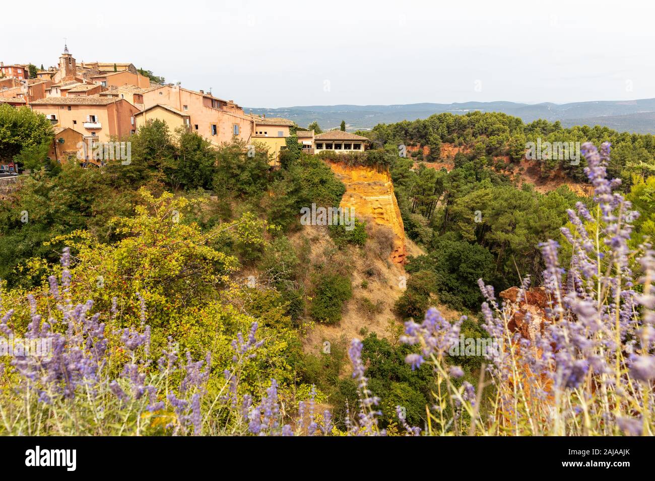 Ochre Trail in Roussillon, Sentier des Ocres, hiking path in a natural colorful area of red and yellow cliffs in a disused ocher pigment quarry surrou Stock Photo