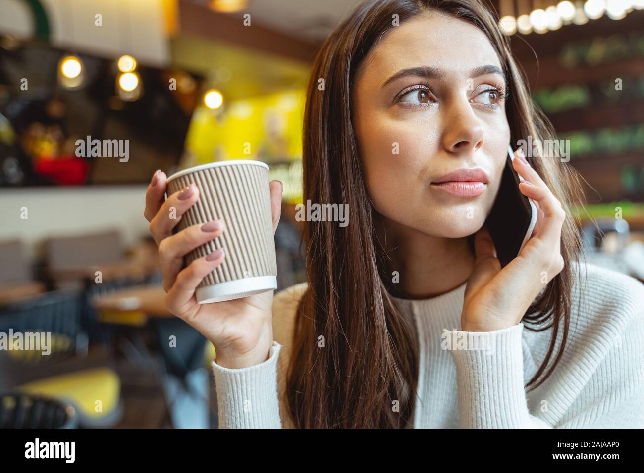 Pretty long haired girl being in all ears Stock Photo