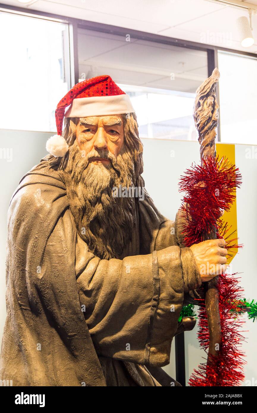 Statue sculpture of Ian McKellen as Gandalf with Santa hat and glitter, Tourist Office I-Site, December 2019, Wellington, New Zealand Stock Photo