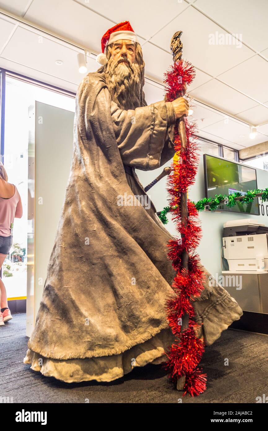 Statue sculpture of Ian McKellen as Gandalf with Santa hat and glitter, Tourist Office I-Site, December 2019, Wellington, New Zealand Stock Photo
