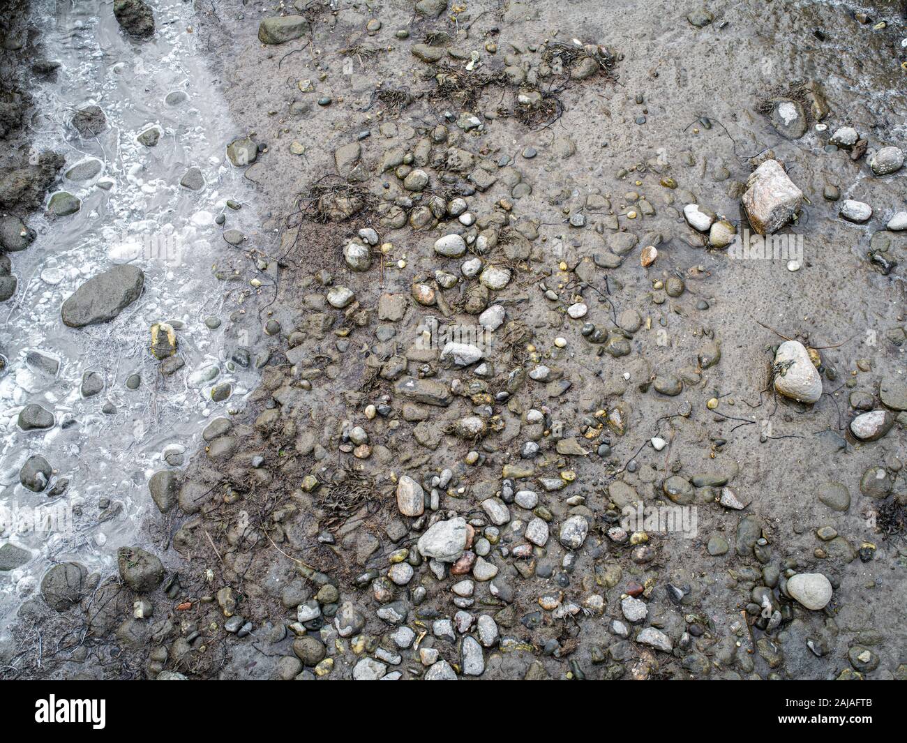 A Dried up River Bed at Low Tide with Brackish Water Stock Photo