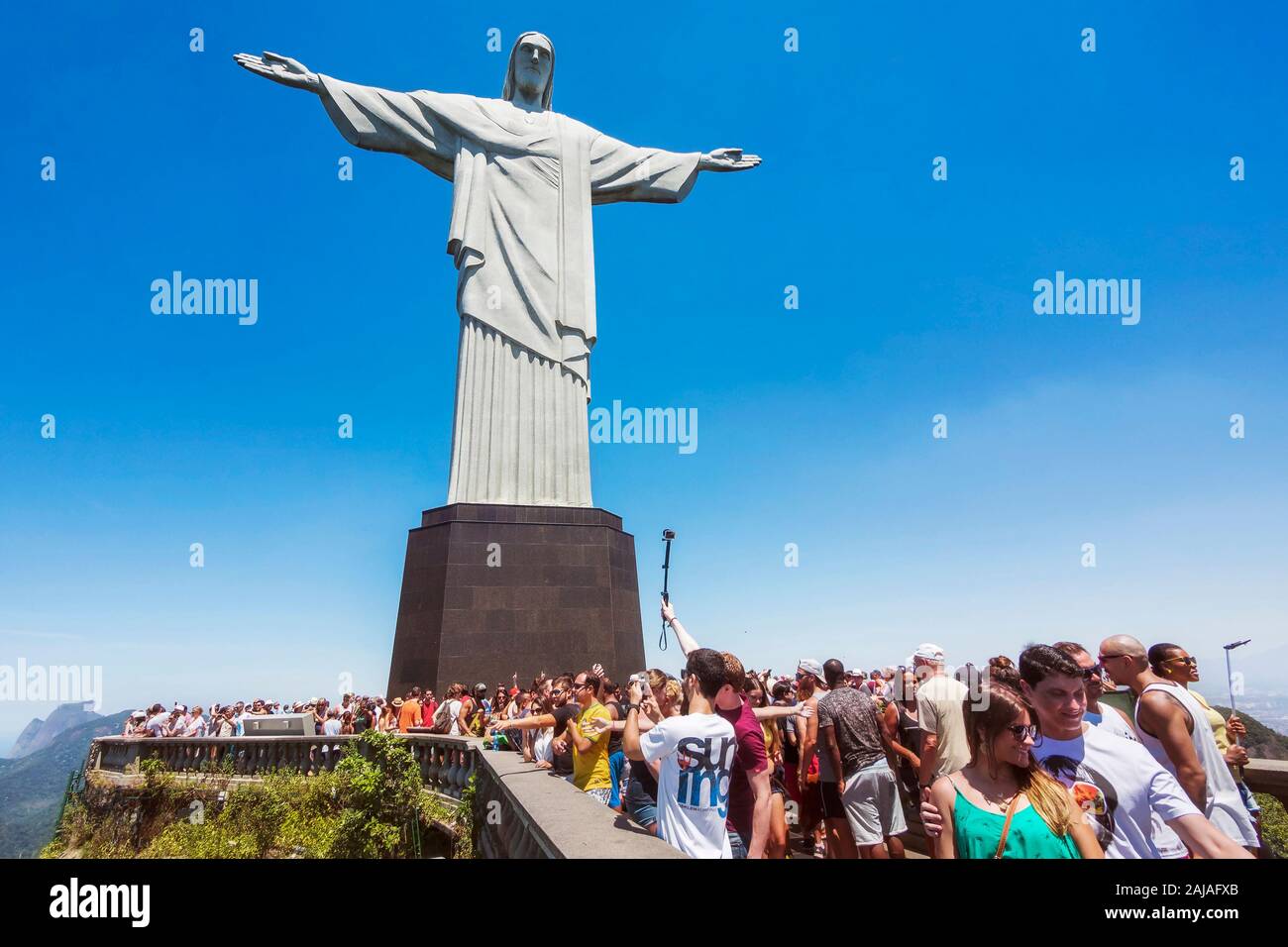 Tourists at the Christ the Redeemer statue atop the Corcovado Mountain in Rio de Janeiro, Brazil. Stock Photo