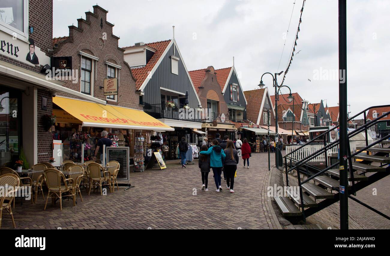 View of people walking at the pier, shops and restaurants in Volendam