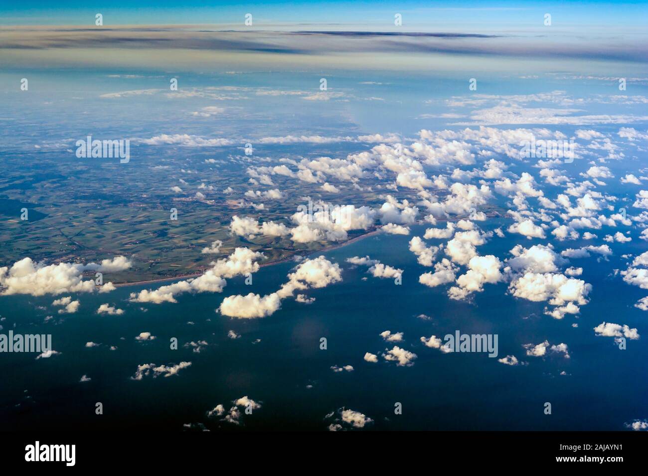 View of the clouds and sky above from the airplane window Stock Photo ...