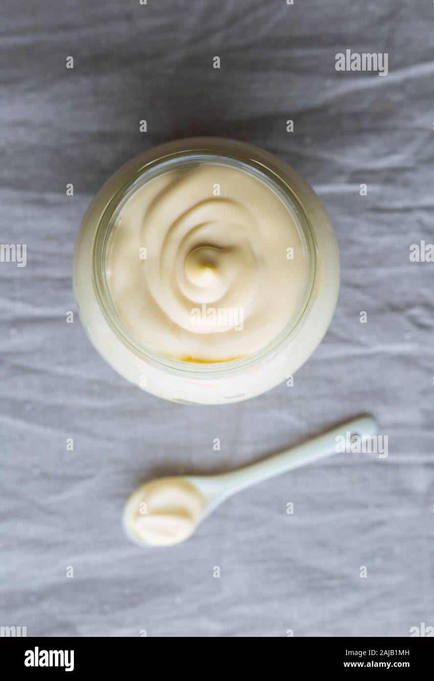 Sour cream in a glass jar. Stock Photo