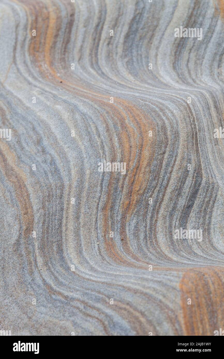 Abstract patterns, shapes and lines in the soft pastel coloured rocks at Spittal beach, Northumberland - geological rock art, North East England. Stock Photo