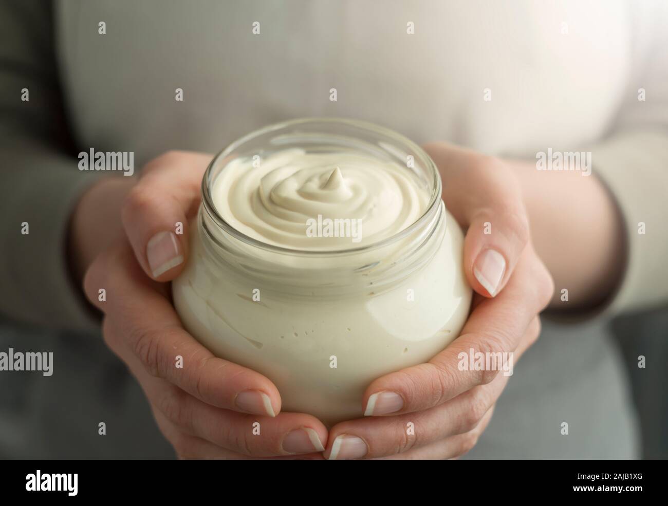 Sour cream in a glass jar. Stock Photo