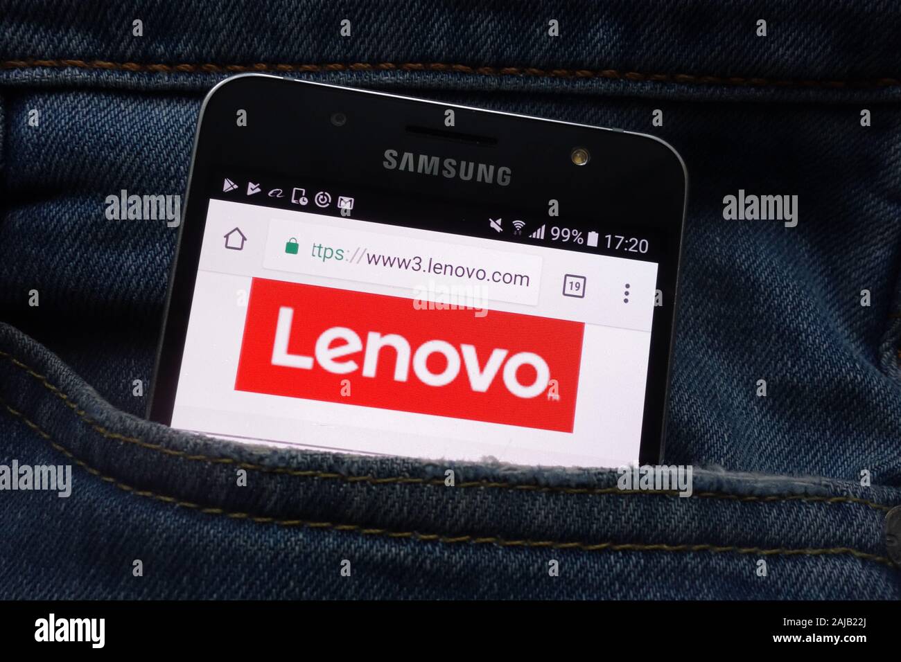 Lenovo website displayed on Samsung smartphone hidden in jeans pocket Stock Photo