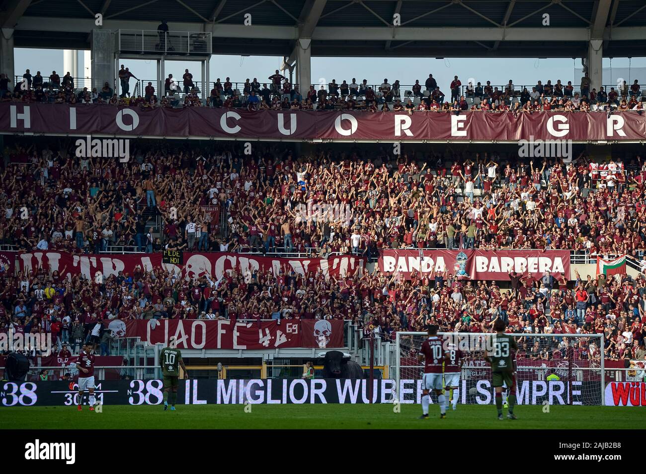 Turin, Italy - 27 October, 2019: Fans of Torino FC in sector 'Curva  Maratona' show their support during the Serie A football match between Torino  FC and Cagliari Calcio. The match ended
