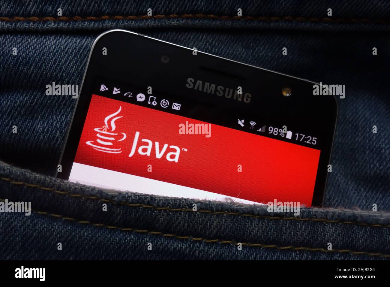 Java website displayed on Samsung smartphone hidden in jeans pocket Stock Photo